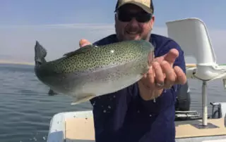 Matt Woessner reels in a big one on a family camping and fishing trip